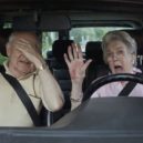 Povinné prohlídky seniorů - Senior woman having trouble learning to drive as man in passenger seat despairs